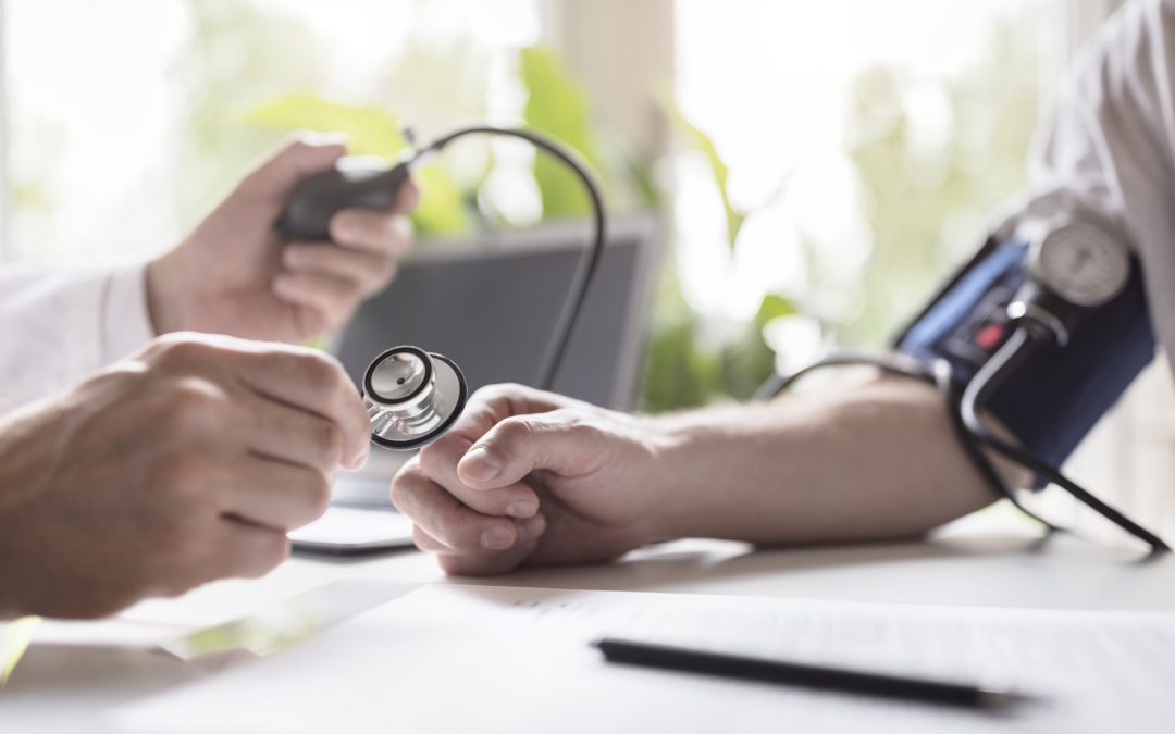 Doctor measuring blood pressure of patient