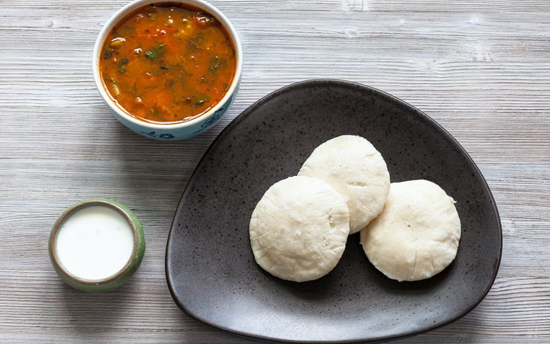 Idli Sambar steamed dumplings with sauses on table