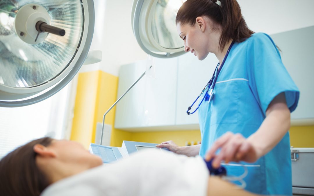 Nurse performing an electrocardiogram test on the patient