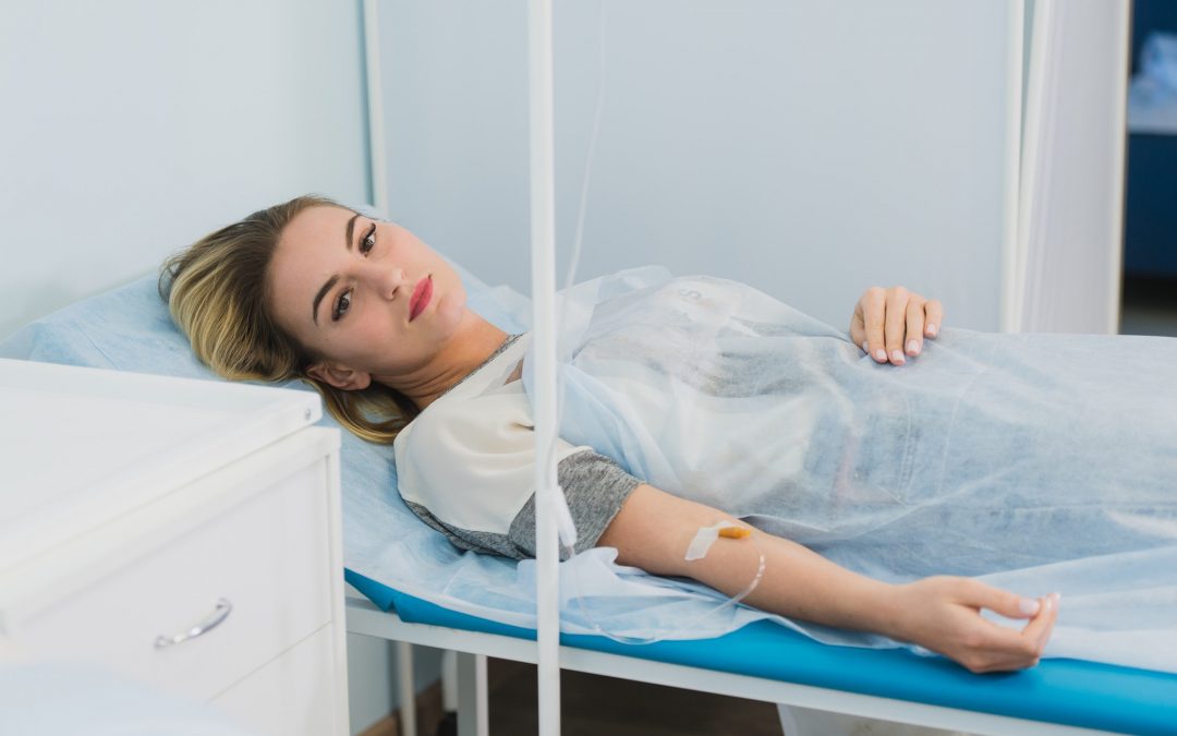 Pensive woman transfused lying in hospital ward